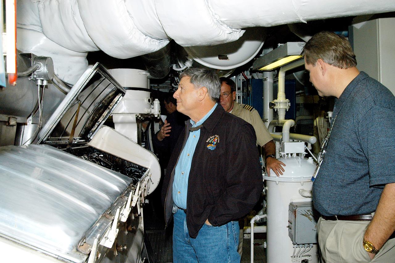 KENNEDY SPACE CENTER, FLA. -- NASA Deputy Associate Administrator for Space Station and Shuttle Programs Michael Kostelnik (left) tours a solid rocket booster (SRB) retrieval ship at Cape Canaveral.  NASA and United Space Alliance (USA) Space Shuttle program management are participating in a leadership workday.  The day is intended to provide management with an in-depth, hands-on look at Shuttle processing activities at KSC.