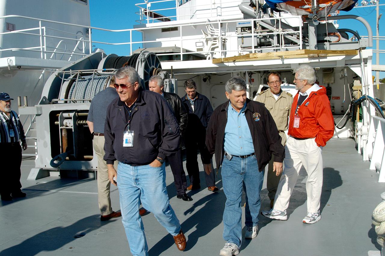 KENNEDY SPACE CENTER, FLA. -- United Space Alliance (USA) Vice President and Associate Program Manager of Florida Operations Bill Pickavance (left front) and NASA Deputy Associate Administrator for Space Station and Shuttle Programs Michael Kostelnik (right front) tour a solid rocket booster (SRB) retrieval ship at Cape Canaveral.  NASA and USA Space Shuttle program management are participating in a leadership workday.  The day is intended to provide management with an in-depth, hands-on look at Shuttle processing activities at KSC.