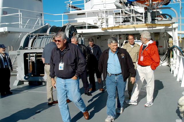 NASA image: KENNEDY SPACE CENTER, FLA. -- United Space Alliance (USA) Vice President and Associate Program Manager of Florida Operations Bill Pickavance (left front) and NASA Deputy Associate Administrator for Space Station and Shuttle Programs Michael Kostelnik (right front) tour a solid rocket booster (SRB) retrieval ship at Cape Canaveral.  NASA and USA Space Shuttle program management are participating in a leadership workday.  The day is intended to provide management with an in-depth, hands-on look at Shuttle processing activities at KSC.