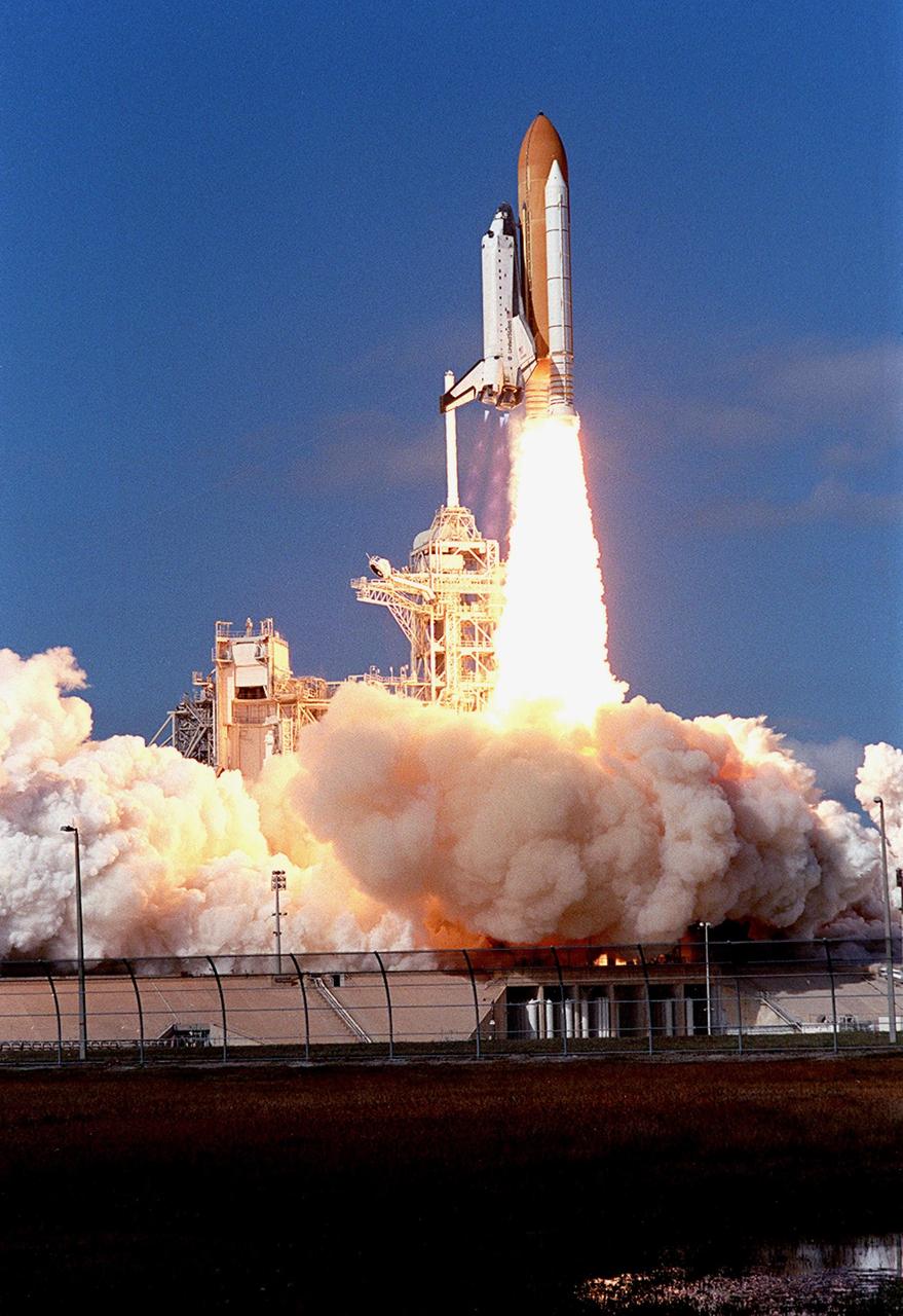 KENNEDY SPACE CENTER, FLA. - Space Shuttle Columbia leaps off Launch Pad 39A and the clouds of smoke and steam as it races toward space on mission STS-107. Following a flawless and uneventful countdown, liftoff occurred on-time at 10:39 a.m. EST.  The 16-day research mission includes FREESTAR (Fast Reaction Experiments Enabling Science, Technology, Applications and Research) and the SHI Research Double Module (SHI/RDM), known as SPACEHAB.  Experiments on the module range from material sciences to life sciences..  Landing of Columbia is scheduled at about 8:53 a.m. EST on Saturday, Feb. 1.  This mission is the first Shuttle mission of 2003. Mission STS-107 is the 28th flight of the orbiter Columbia and the 113th flight overall in NASA's Space Shuttle program. 
