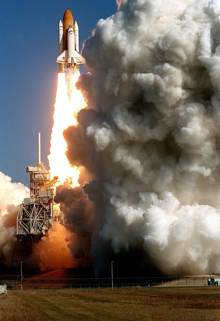 KENNEDY SPACE CENTER, FLA. - Space Shuttle Columbia outraces the multi-colored clouds of smoke and steam rising below it from Launch Pad 39A as it races toward space on mission STS-107. Following a flawless and uneventful countdown, liftoff occurred on-time at 10:39 a.m. EST.  The 16-day research mission includes FREESTAR (Fast Reaction Experiments Enabling Science, Technology, Applications and Research) and the SHI Research Double Module (SHI/RDM), known as SPACEHAB.  Experiments on the module range from material sciences to life sciences..  Landing of Columbia is scheduled at about 8:53 a.m. EST on Saturday, Feb. 1.  This mission is the first Shuttle mission of 2003. Mission STS-107 is the 28th flight of the orbiter Columbia and the 113th flight overall in NASA's Space Shuttle program. 