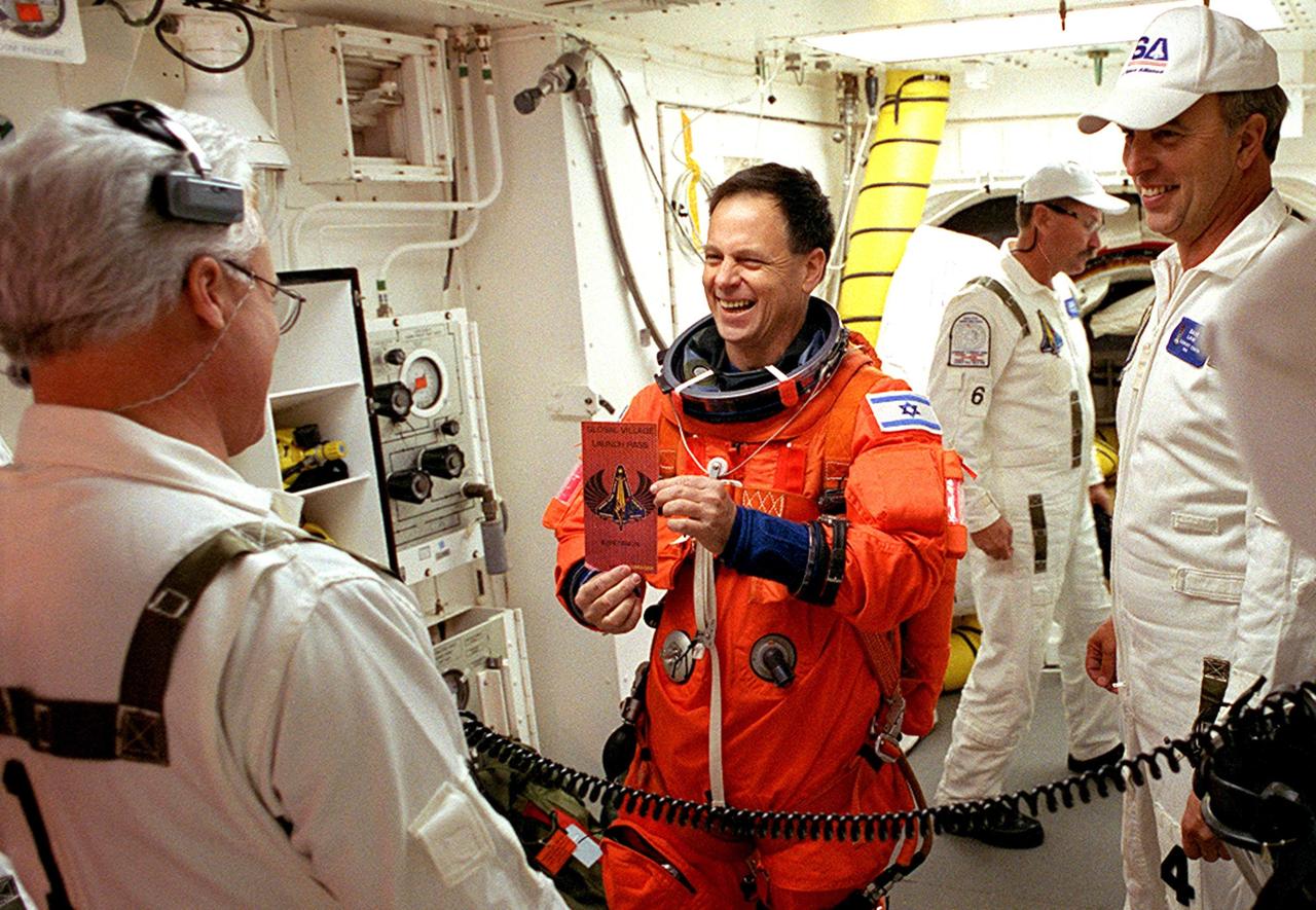 KENNEDY SPACE CENTER, FLA. -- STS-107 Payload Specialist Ilan Ramon, who represents the Israel Space Agency, chats with the Closeout Crew in the White Room before entering Columbia. The environmentally controlled chamber is mated to Space Shuttle Columbia for entry into the Shuttle. Ramon is the first Israeli astronaut to fly in the Shuttle. STS-107 is a mission devoted to research and will include more than 80 experiments that will study Earth and space science, advanced technology development, and astronaut health and safety. The payload on Space Shuttle Columbia includes FREESTAR (Fast Reaction Experiments Enabling Science, Technology, Applications and Research) and the SHI Research Double Module (SHI/RDM), known as SPACEHAB. Experiments on the module range from material sciences to life sciences. Liftoff is scheduled for 10:39 a.m. EST.