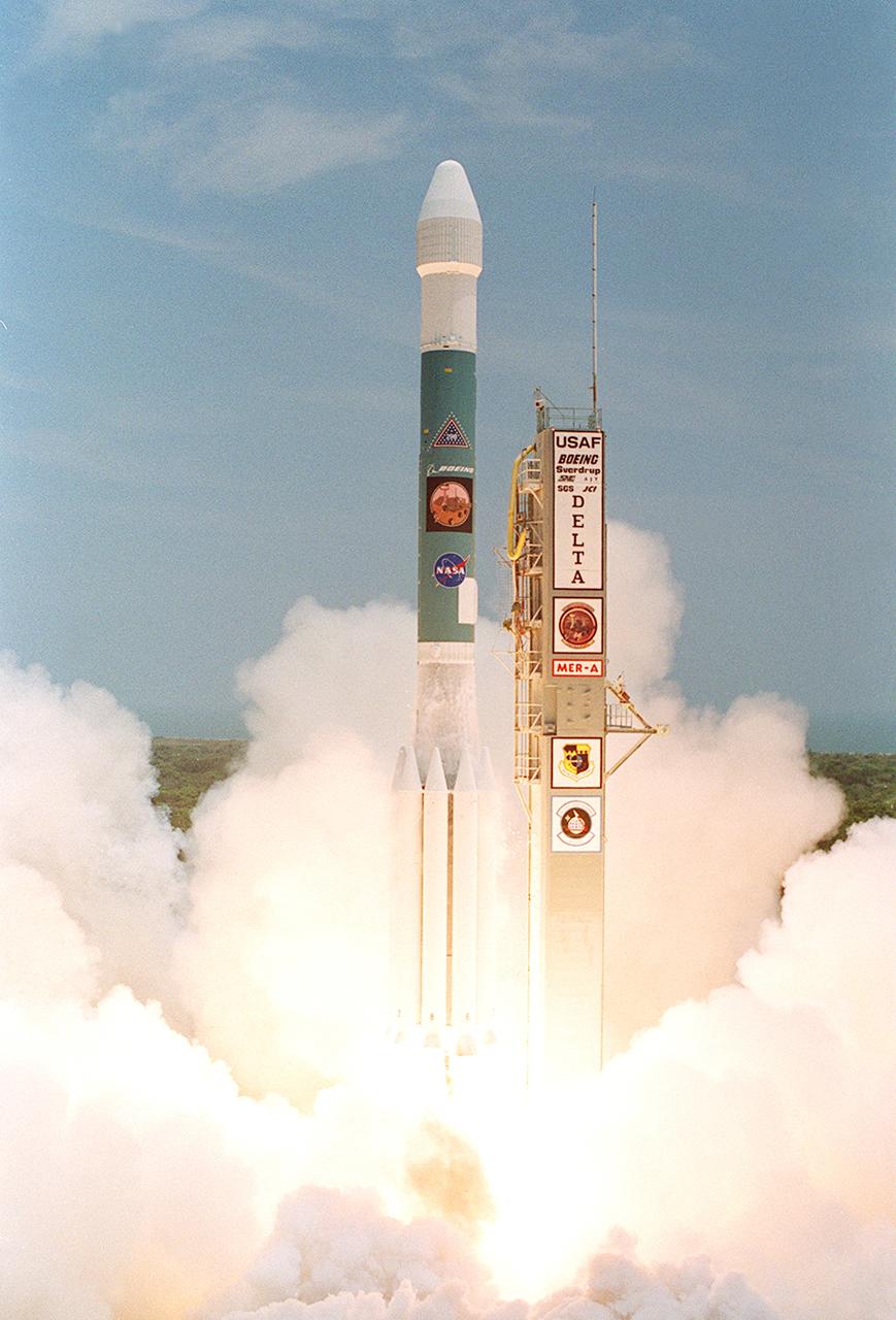 KENNEDY SPACE CENTER, FLA. -    The Delta II rocket with its Mars Exploration Rover (MER-A) payload breaks forth from the smoke and steam into the blue sky to begin its journey to Mars.  Liftoff occurred on time at 1:58 p.m. EDT from Launch Complex 17-A, Cape Canaveral Air Force Station.  MER-A, known as "Spirit," is the first of two rovers being launched to Mars. When the two rovers arrive at the red planet in 2004, they will bounce to airbag-cushioned landings at sites offering a balance of favorable conditions for safe landings and interesting science. The rovers see sharper images, can explore farther and examine rocks better than anything that has ever landed on Mars. The designated site for the MER-A mission is Gusev Crater, which appears to have been a crater lake. The second rover, MER-B, is scheduled to launch June 25