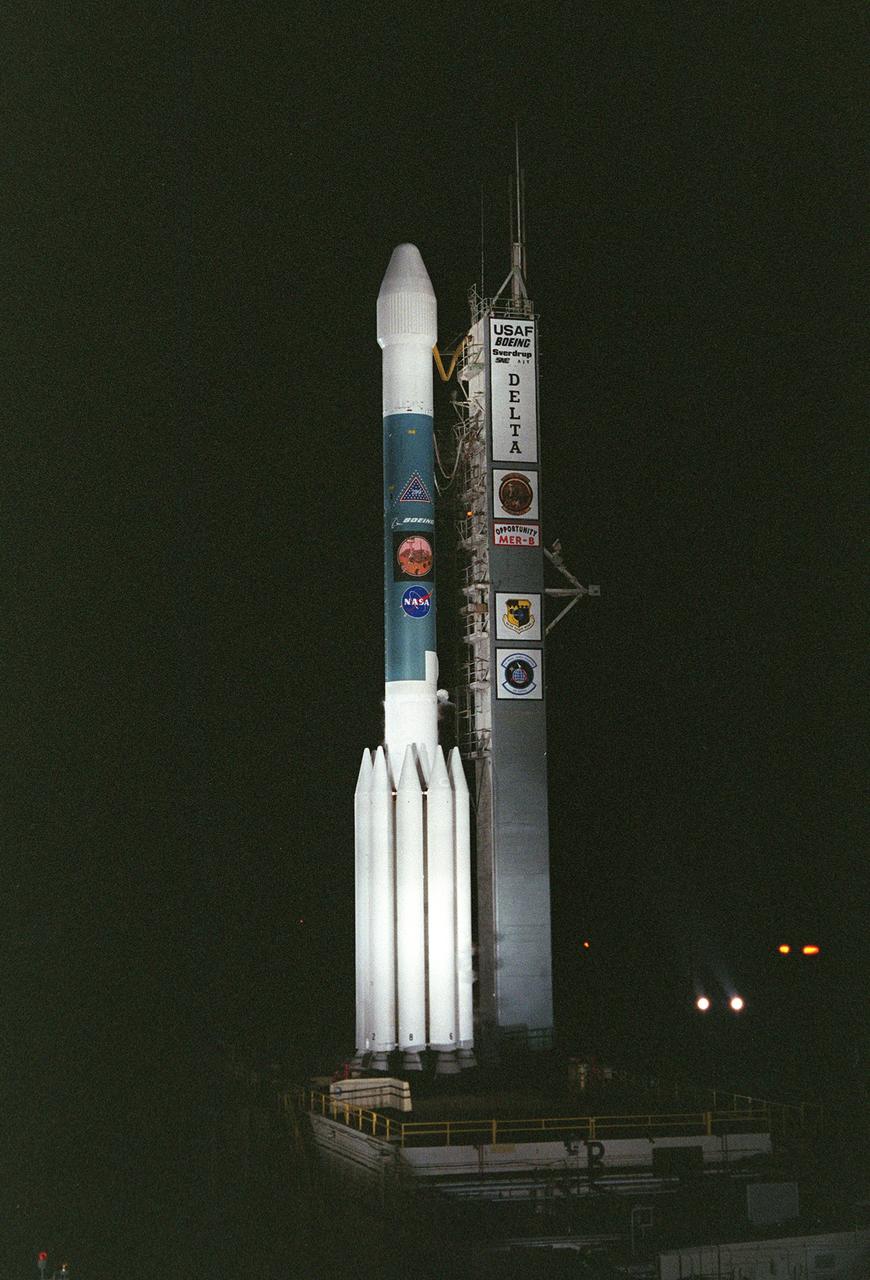 KENNEDY SPACE CENTER, FLA. - On Launch Complex 17-B, Cape Canaveral Air Force Station, the Delta II Heavy launch vehicle carrying the second Mars Exploration Rover, Opportunity, is poised for launch after rollback of the Mobile Service Tower. Opportunity will reach Mars on Jan. 25, 2004. Together the two MER rovers, Spirit (launched June 10) and Opportunity, seek to determine the history of climate and water at two sites on Mars where conditions may once have been favorable to life. The rovers are identical. They will navigate themselves around obstacles as they drive across the Martian surface, traveling up to about 130 feet each Martian day. Each rover carries five scientific instruments including a panoramic camera and microscope, plus a rock abrasion tool that will grind away the outer surfaces of rocks to expose their interiors for examination. Each rover’s prime mission is planned to last three months on Mars.