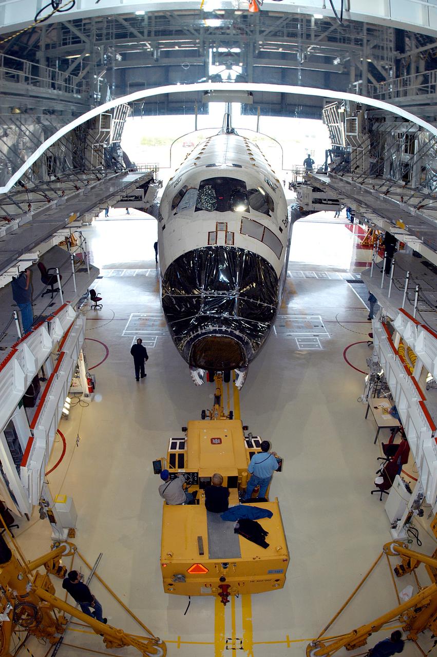 KENNEDY SPACE CENTER, FLA. -- Endeavour begins rolling out of the Orbiter Processing Facility for temporary transfer to the Vehicle Assembly Building. The move allows work to be performed in the OPF that can only be accomplished while the bay is empty. Work scheduled in the OPF includes annual validation of the bay’s cranes, work platforms, lifting mechanisms and jack stands. Endeavour will remain in the VAB for approximately 12 days, then return to the OPF.