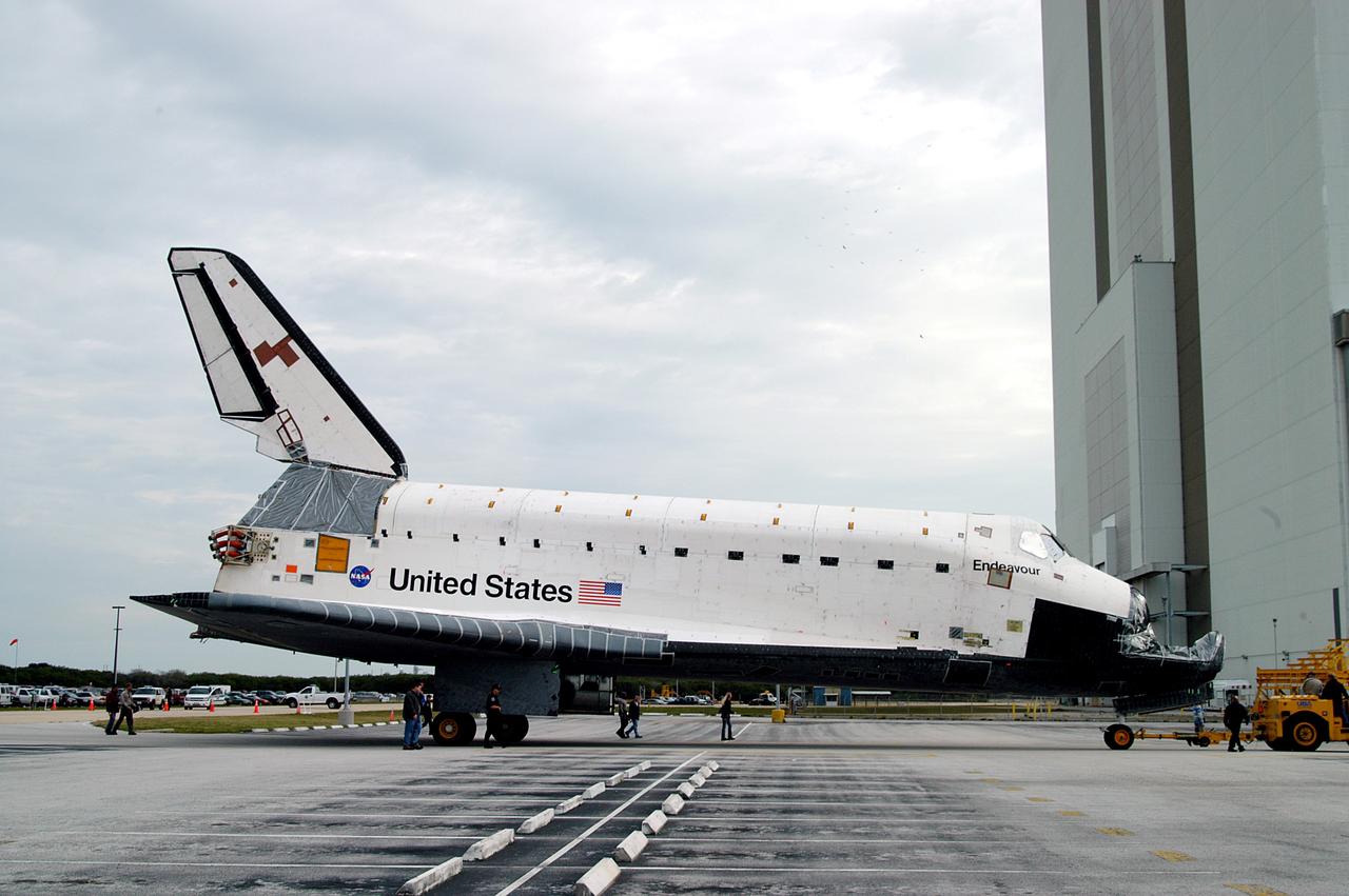KENNEDY SPACE CENTER, FLA. -- Endeavour is towed in front of the Vehicle Assembly Building (VAB) where it is going for temporary storage.  The orbiter has been moved from the Orbiter Processing Facility (OPF) to allow work to be performed in the OPF that can only be accomplished while the bay is empty. Work scheduled in the OPF includes annual validation of the bay’s cranes, work platforms, lifting mechanisms and jack stands. Endeavour will remain in the VAB for approximately 12 days, then return to the OPF.