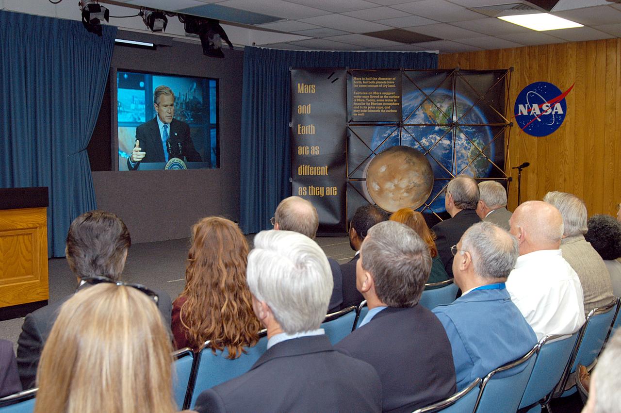 KENNEDY SPACE CENTER, FLA. -- KSC management and other employees gather in the Center’s television studio to watch the address by President George W. Bush from NASA Headquarters stating his goals for NASA’s new mission. Seated in the front row, left to right, are Ken Aguilar, chief, Equal Opportunity office; Lisa Malone, director of External Affairs; Bruce Buckingham, assistant to Dr. Woodrow Whitlow, KSC deputy director; Dr. Whitlow; Shannon Roberts, with External Affairs; Howard DeCastro, vice president and Space Shuttle program manager, United Space Alliance; and Bill Pickavance vice president and associate program manager of Florida Operations, USA. The President’s goals are completing the International Space Station, retiring the Space Shuttle orbiters, developing a new crew exploration vehicle, and returning to the moon and beyond within the next two decades. Pres. Bush was welcomed by NASA Administrator Sean O’Keefe and Expedition 8 Commander Michael Foale, who greeted him from the International Space Station. Members of the Washington, D.C., audience included astronauts Eileen Collins, Ed Lu and Michael Lopez-Alegria, and former astronaut Gene Cernan.