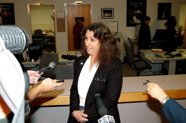 NASA image: KENNEDY SPACE CENTER, FLA. -- Maria Littlefield, chief technologist with the Launch Services Program Office, talks to the media at the NASA-KSC News Center after viewing President George W. Bush’s message on the future of NASA.  The President stated his goals for NASA’s new mission: Completing the International Space Station, retiring the Space Shuttle orbiters, developing a new crew exploration vehicle, and returning to the moon and beyond within the next two decades.   Pres. Bush was welcomed by NASA Administrator Sean O’Keefe and Expedition 8 Commander Michael Foale, who greeted him from the International Space Station.