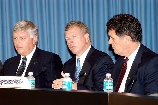 NASA image: KENNEDY SPACE CENTER, FLA. -- At a press conference, U.S. Rep. Tom Feeney responds to a question from a reporter about the new mission for NASA outlined by President George W. Bush Jan. 14.  Present with Feeney are Center Director Jim Kennedy (left) and U.S. Rep. Dave Weldon (right).