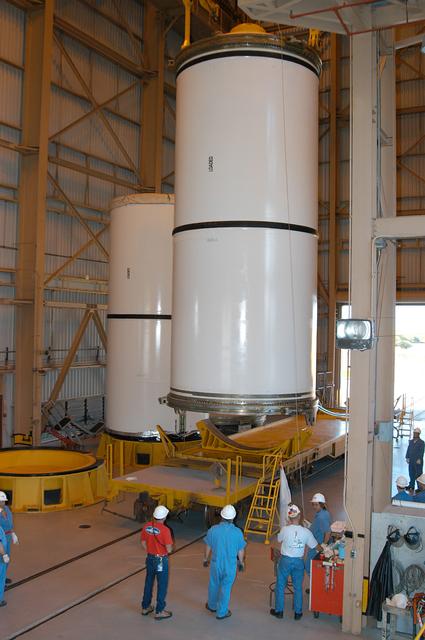 NASA image: KENNEDY SPACE CENTER, FLA. -  In the Rotation Processing and Surge Facility, an SRB solid segment is being moved to a rail car for shipment to Utah for testing.  The segment was part of the STS-114 stack.  It is the first time actual flight segments that had been stacked for flight in the VAB are being returned to Utah for testing.  It will undergo firing, which will enable inspectors to check the viability of the solid and verify the life expectancy for stacked segments.