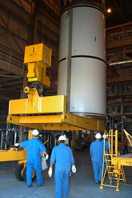 NASA image: KENNEDY SPACE CENTER, FLA. -  In the Rotation Processing and Surge Facility, an SRB solid segment is being lifted and moved to a rail car for shipment to Utah for testing.  The segment was part of the STS-114 stack.  It is the first time actual flight segments that had been stacked for flight in the VAB are being returned to Utah for testing.  It will undergo firing, which will enable inspectors to check the viability of the solid and verify the life expectancy for stacked segments.