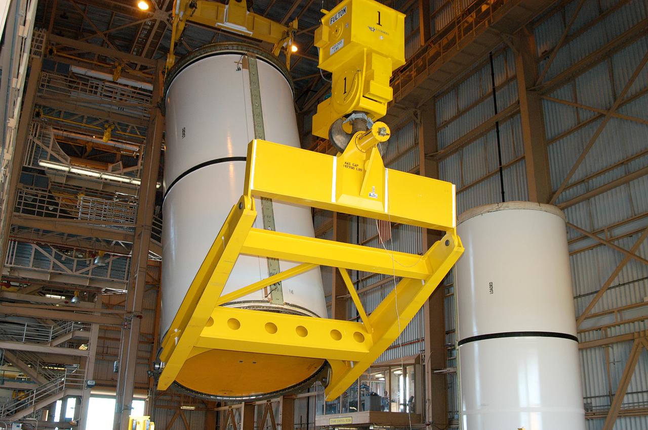 KENNEDY SPACE CENTER, FLA. -  In the Rotation Processing and Surge Facility, an SRB solid segment is being lifted and moved to a rail car for shipment to Utah for testing.  The segment was part of the STS-114 stack.  It is the first time actual flight segments that had been stacked for flight in the VAB are being returned to Utah for testing.  It will undergo firing, which will enable inspectors to check the viability of the solid and verify the life expectancy for stacked segments.