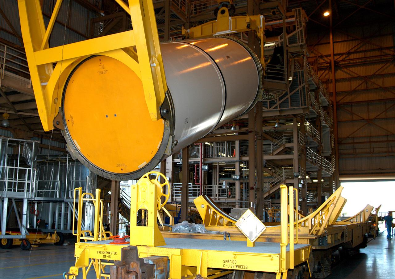 KENNEDY SPACE CENTER, FLA. - In the Rotation Processing and Surge Facility, an SRB solid segment is being rotated to horizontal for placement on a rail car. The segment is being shipped to Utah for testing. The segment was part of the STS-114 stack. It is the first time actual flight segments that had been stacked for flight in the VAB are being returned to Utah for testing. It will undergo firing, which will enable inspectors to check the viability of the solid and verify the life expectancy for stacked segments.
