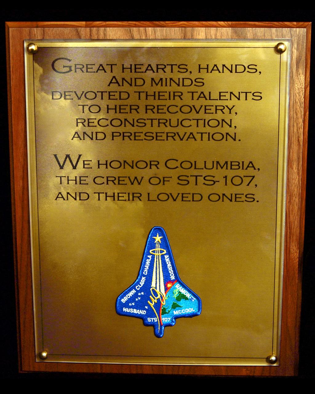 KENNEDY SPACE CENTER, FLA. -  This closeup shows the words of the plaque unveiled Jan. 29, 2004, that was dedicated in memory of the orbiter Columbia and her seven-member crew who were lost in the tragic accident Feb. 1, 2003, as they returned to Earth from mission STS-107.  The dedication of the plaque was made in front of the 40-member preservation team in the “Columbia room,” a permanent repository in the Vehicle Assembly Building of the debris collected in the aftermath of the accident.