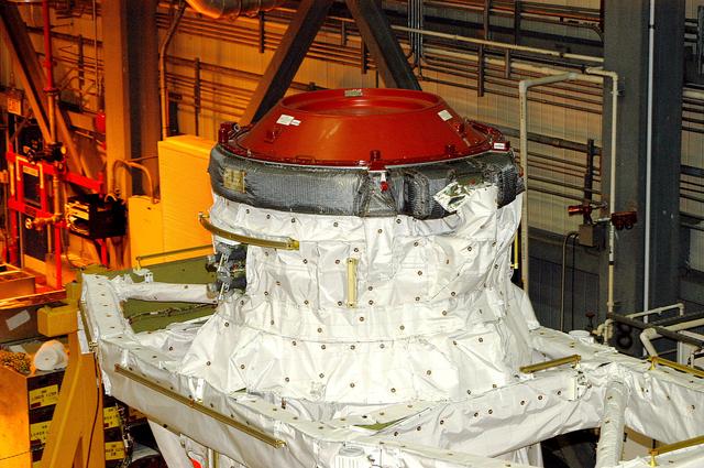 NASA image: KENNEDY SPACE CENTER, FLA. -  Seen in the photo is one end of the airlock that is installed in the payload bay of orbiter Discovery.  The airlock is normally located inside the middeck of the spacecraft’s pressurized crew cabin. The airlock is sized to accommodate two fully suited flight crew members simultaneously. Support functions include airlock depressurization and repressurization, extravehicular activity equipment recharge, liquid-cooled garment water cooling, EVA equipment checkout, donning and communications. The outer hatch isolates the airlock from the unpressurized payload bay when closed and permits the EVA crew members to exit from the airlock to the payload bay when open.