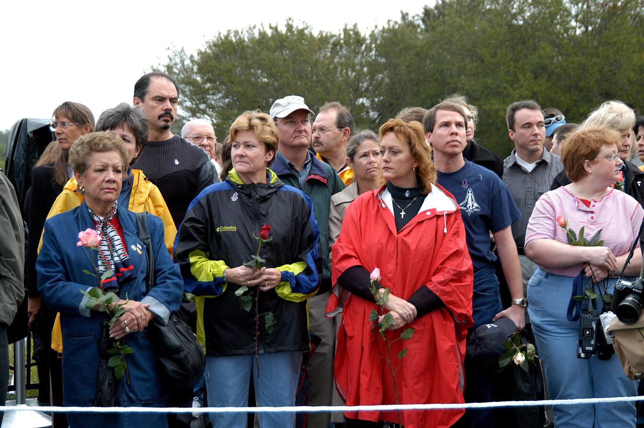 KENNEDY SPACE CENTER, FLA. -  Friends, co-workers and families gather at the Space Memorial Mirror for KSC’s special service remembering and honoring the crew of Columbia.  Feb. 1 is the one-year anniversary of the loss of the crew and orbiter Columbia in a tragic accident as the ship returned to Earth following mission STS-107.  The public was invited to the memorial service held at the KSC Visitor Complex.  Participants included Center Director Jim Kennedy, Deputy Director Woodrow Whitlow Jr., Executive Director of Florida Space Authority Winston Scott, Dr. Stephen Feldman, president of the Astronaut Memorial Foundation, and dancers from the Shoshone-Bannock Native American community in Fort Hall, Idaho.