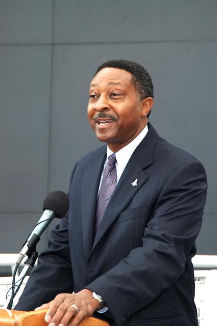 KENNEDY SPACE CENTER, FLA. -  Winston Scott, executive director of Florida Space Authority, speaks to attendees at a memorial service honoring the crew of Columbia.  He stands in front of the Space Memorial Mirror at the KSC Visitor Complex.  Feb. 1 is the one-year anniversary of the loss of the crew and orbiter Columbia in a tragic accident as the ship returned to Earth following mission STS-107.  Scott is a former astronaut who flew on Columbia in 1997.  Attended by many friends, co-workers and families, the memorial service was also open to the public.