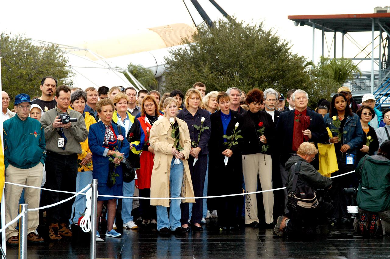 KENNEDY SPACE CENTER, FLA. -  Friends, co-workers and families gather at the Space Memorial Mirror for KSC’s special service remembering and honoring the crew of Columbia.  Feb. 1 is the one-year anniversary of the loss of the crew and orbiter Columbia in a tragic accident as the ship returned to Earth following mission STS-107.  The public was invited to the memorial service held at the KSC Visitor Complex.  Participants included Center Director Jim Kennedy, Deputy Director Woodrow Whitlow Jr., Executive Director of Florida Space Authority Winston Scott, Dr. Stephen Feldman, president of the Astronaut Memorial Foundation, and dancers from the Shoshone-Bannock Native American community in Fort Hall, Idaho.