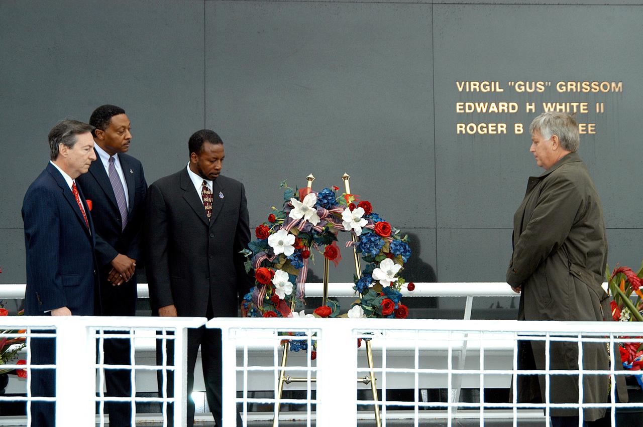 KENNEDY SPACE CENTER, FLA. -  During a memorial service remembering and honoring the crew of Columbia, President of the Astronaut Memorial Foundation Dr. Stephen Feldman, Executive Director of Florida Space Authority Winston Scott, KSC Deputy Director Woodrow Whitlow Jr. and Center Director Jim Kennedy pause after placing a wreath in front of the Space Memorial Mirror.  Feb. 1 is the one-year anniversary of the loss of the crew and orbiter Columbia in a tragic accident as the ship returned to Earth following mission STS-107.  Scott is a former astronaut who flew on Columbia in 1997. The public was also invited to the memorial service.