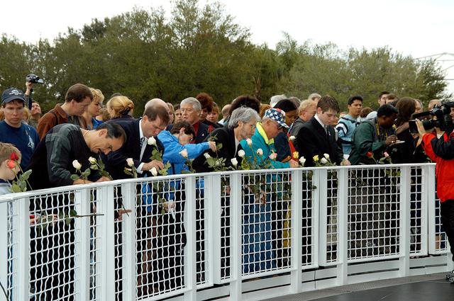 NASA image: KENNEDY SPACE CENTER, FLA. -  Following the memorial service for the crew of Columbia at the Space Memorial Mirror, visitors place roses in the wire mesh fence surrounding the mirror.  Feb. 1 is the one-year anniversary of the loss of the crew and orbiter Columbia in a tragic accident as the ship returned to Earth following mission STS-107.  Scott is a former astronaut who flew on Columbia in 1997. The public was invited to the memorial service, which included comments by Center Director Jim Kennedy and Executive Director of Florida Space Authority Winston Scott.  Scott is a former astronaut who flew on Columbia in 1997.