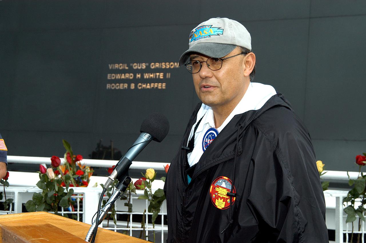 KENNEDY SPACE CENTER, FLA. - Dr. Ed Galindo speaks to the visitors at the memorial service held at the Space Memorial Mirror for the crew of Columbia.  Galindo is science educator of Shoshone-Bannock High School and introduced the dancers from the Shoshone-Bannock Native American community in Fort Hall, Idaho.  The dancers performed a healing ceremony during the memorial.  Students and staff of the Shoshone-Bannock Nation had an experiment on board Columbia. Feb. 1 is the one-year anniversary of the loss of the crew and orbiter Columbia in a tragic accident as the ship returned to Earth following mission STS-107. The public was invited to the memorial service, held in the KSC Visitor Complex, which included comments by Center Director Jim Kennedy and Executive Director of Florida Space Authority Winston Scott.  Scott is a former astronaut who flew on Columbia in 1997.