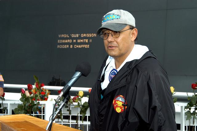 NASA image: KENNEDY SPACE CENTER, FLA. - Dr. Ed Galindo speaks to the visitors at the memorial service held at the Space Memorial Mirror for the crew of Columbia.  Galindo is science educator of Shoshone-Bannock High School and introduced the dancers from the Shoshone-Bannock Native American community in Fort Hall, Idaho.  The dancers performed a healing ceremony during the memorial.  Students and staff of the Shoshone-Bannock Nation had an experiment on board Columbia. Feb. 1 is the one-year anniversary of the loss of the crew and orbiter Columbia in a tragic accident as the ship returned to Earth following mission STS-107. The public was invited to the memorial service, held in the KSC Visitor Complex, which included comments by Center Director Jim Kennedy and Executive Director of Florida Space Authority Winston Scott.  Scott is a former astronaut who flew on Columbia in 1997.