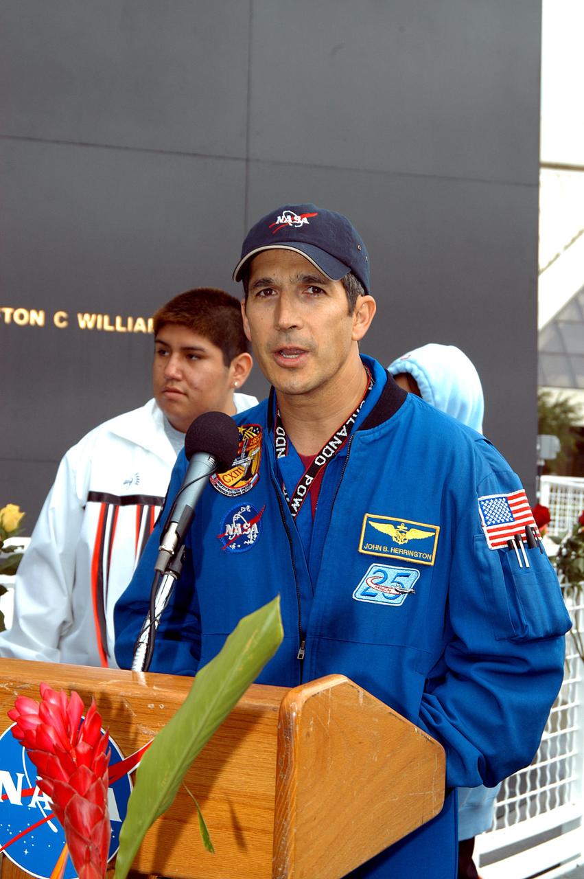 KENNEDY SPACE CENTER, FLA. - Astronaut John Herrington speaks to the visitors at the memorial service held at the Space Memorial Mirror for the crew of Columbia.  Herrington, who is a Chickasaw from Oklahoma, introduced the Shoshone-Bannock Junior-Senior High School dancers, from the Native American community at Fort Hall, Idaho, who performed a healing ceremony.  Students and staff of the Shoshone-Bannock Nation had an experiment on board Columbia. Feb. 1 is the one-year anniversary of the loss of the crew and orbiter Columbia in a tragic accident as the ship returned to Earth following mission STS-107. The public was invited to the memorial service, held in the KSC Visitor Complex, which included comments by Center Director Jim Kennedy and Executive Director of Florida Space Authority Winston Scott.  Scott is a former astronaut who flew on Columbia in 1997.