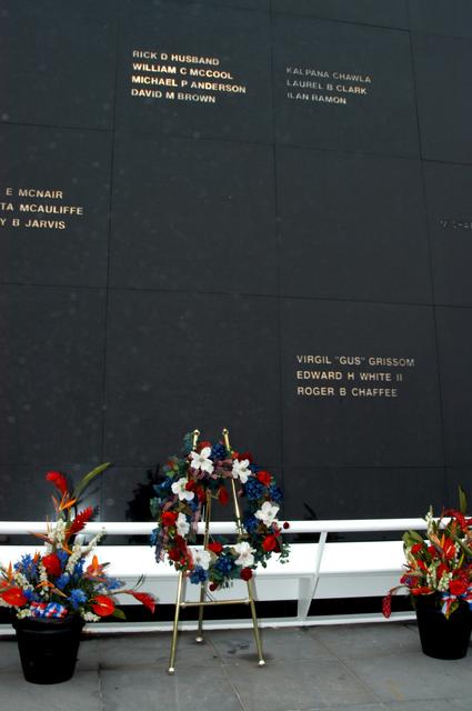 NASA image: KENNEDY SPACE CENTER, FLA. - A wreath and other floral arrangements rest beneath the Astronaut Memorial Mirror at the KSC Visitor Complex following a memorial service held for the crew of Columbia on the anniversary of the tragic accident that took their lives Feb. 1, 2003. The black granite mirror honors astronauts, whose names are carved in the surface, who have given their lives for space exploration.  The service included comments by Center Director Jim Kennedy, Deputy Director Woodrow Whitlow Jr., Executive Director of Florida Space Authority Winston Scott, and Dr. Stephen Feldman, president of the Astronaut Memorial Foundation, who placed the wreath at the mirror.
