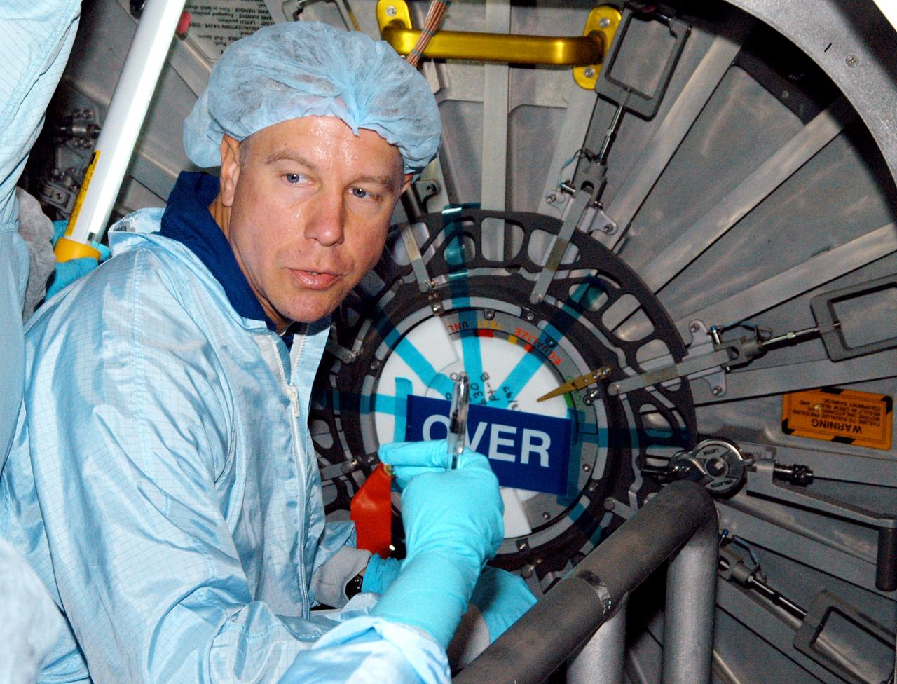 KENNEDY SPACE CENTER, FLA. - Astronaut Tim Kopra aids in Intravehicular Activity (IVA) constraints testing on the Italian-built Node 2, a future element of the International Space Station.  The second of three Station connecting modules, the Node 2 attaches to the end of the U.S. Lab and provides attach locations for several other elements.  Kopra is currently assigned technical duties in the Space Station Branch of the Astronaut Office, where his primary focus involves the testing of crew interfaces for two future ISS modules as well as the implementation of support computers and operational Local Area Network on ISS.   Node 2 is scheduled to launch on mission STS-120, Station assembly flight 10A.