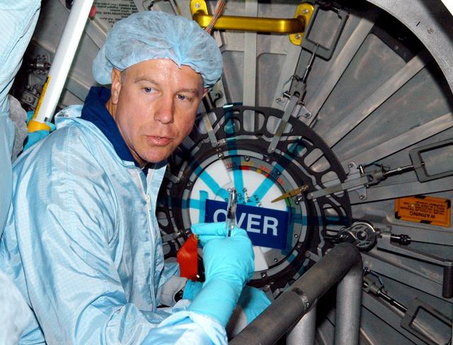 KENNEDY SPACE CENTER, FLA. - Astronaut Tim Kopra aids in Intravehicular Activity (IVA) constraints testing on the Italian-built Node 2, a future element of the International Space Station.  The second of three Station connecting modules, the Node 2 attaches to the end of the U.S. Lab and provides attach locations for several other elements.  Kopra is currently assigned technical duties in the Space Station Branch of the Astronaut Office, where his primary focus involves the testing of crew interfaces for two future ISS modules as well as the implementation of support computers and operational Local Area Network on ISS.   Node 2 is scheduled to launch on mission STS-120, Station assembly flight 10A.