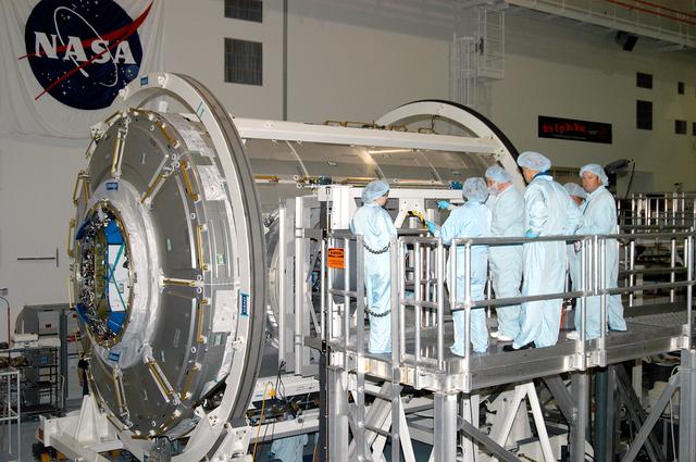 KENNEDY SPACE CENTER, FLA. - In the Space Station Processing Facility, workers check over the Italian-built Node 2, a future element of the International Space Station.  The second of three Station connecting modules, the Node 2 attaches to the end of the U.S. Lab and provides attach locations for several other elements.  Kopra is currently assigned technical duties in the Space Station Branch of the Astronaut Office, where his primary focus involves the testing of crew interfaces for two future ISS modules as well as the implementation of support computers and operational Local Area Network on ISS.   Node 2 is scheduled to launch on mission STS-120, Station assembly flight 10A.