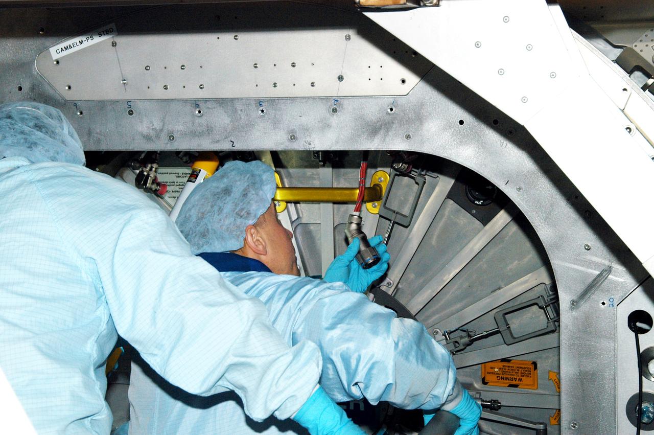 KENNEDY SPACE CENTER, FLA. - Astronaut Tim Kopra aids in Intravehicular Activity (IVA) constraints testing on the Italian-built Node 2, a future element of the International Space Station.  The second of three Station connecting modules, the Node 2 attaches to the end of the U.S. Lab and provides attach locations for several other elements.  Kopra is currently assigned technical duties in the Space Station Branch of the Astronaut Office, where his primary focus involves the testing of crew interfaces for two future ISS modules as well as the implementation of support computers and operational Local Area Network on ISS.   Node 2 is scheduled to launch on mission STS-120, Station assembly flight 10A.