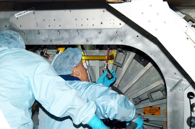 KENNEDY SPACE CENTER, FLA. - Astronaut Tim Kopra aids in Intravehicular Activity (IVA) constraints testing on the Italian-built Node 2, a future element of the International Space Station.  The second of three Station connecting modules, the Node 2 attaches to the end of the U.S. Lab and provides attach locations for several other elements.  Kopra is currently assigned technical duties in the Space Station Branch of the Astronaut Office, where his primary focus involves the testing of crew interfaces for two future ISS modules as well as the implementation of support computers and operational Local Area Network on ISS.   Node 2 is scheduled to launch on mission STS-120, Station assembly flight 10A.