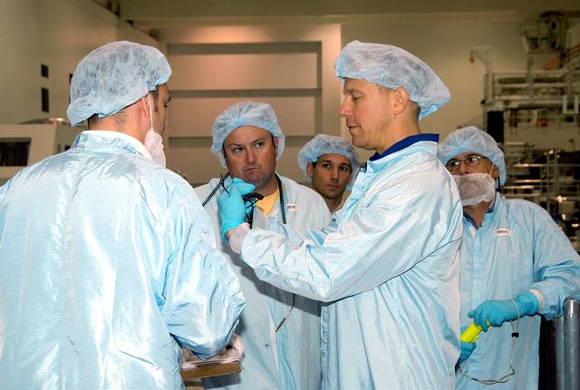 NASA image: KENNEDY SPACE CENTER, FLA. - Astronaut Tim Kopra (second from right) talks with workers in the Space Station Processing Facility about the Intravehicular Activity (IVA) constraints testing on the Italian-built Node 2, a future element of the International Space Station.  .  The second of three Station connecting modules, the Node 2 attaches to the end of the U.S. Lab and provides attach locations for several other elements.  Kopra is currently assigned technical duties in the Space Station Branch of the Astronaut Office, where his primary focus involves the testing of crew interfaces for two future ISS modules as well as the implementation of support computers and operational Local Area Network on ISS.   Node 2 is scheduled to launch on mission STS-120, Station assembly flight 10A.