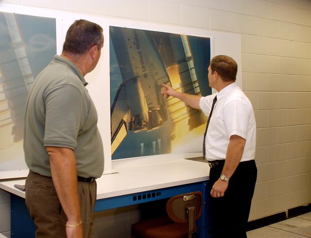 NASA image: KENNEDY SPACE CENTER, FLA. - One of the world’s highest performing visual film analysis systems, developed to review and analyze previous shuttle flight data (shown here) in preparation for the shuttle fleet’s return to flight, is being used today for another purpose.  NASA has permitted its use in helping to analyze a film that shows a recent kidnapping in progress in Florida.  The system, developed by NASA, United Space Alliance (USA) and Silicon Graphics Inc., allows multiple-person collaboration,  highly detailed manipulation and evaluation of specific imagery.  The system is housed in the Image Analysis Facility inside the Vehicle Assembly Building. [Photo taken Aug. 15, 2003, courtesy of Terry Wallace, SGI ]