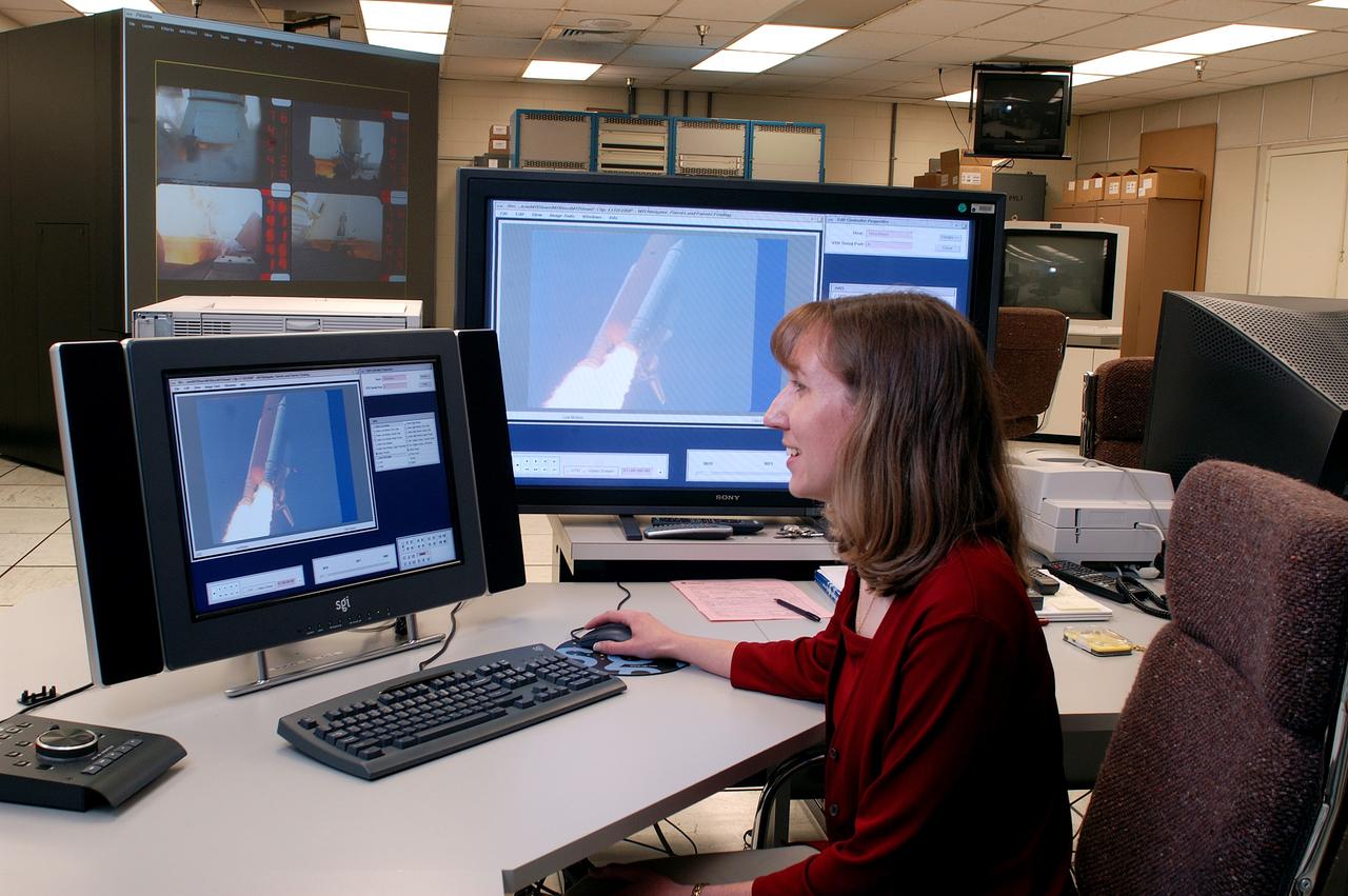 KENNEDY SPACE CENTER, FLA. - One of the world’s highest performing visual film analysis systems, developed to review and analyze previous shuttle flight data (shown here) in preparation for the shuttle fleet’s return to flight, is being used today for another purpose.  NASA has permitted its use in helping to analyze a film that shows a recent kidnapping in progress in Florida.  The system, developed by NASA, United Space Alliance (USA) and Silicon Graphics Inc., allows multiple-person collaboration,  highly detailed manipulation and evaluation of specific imagery.  The system is housed in the Image Analysis Facility inside the Vehicle Assembly Building. [Photo taken Aug. 15, 2003, courtesy of Terry Wallace, SGI ]