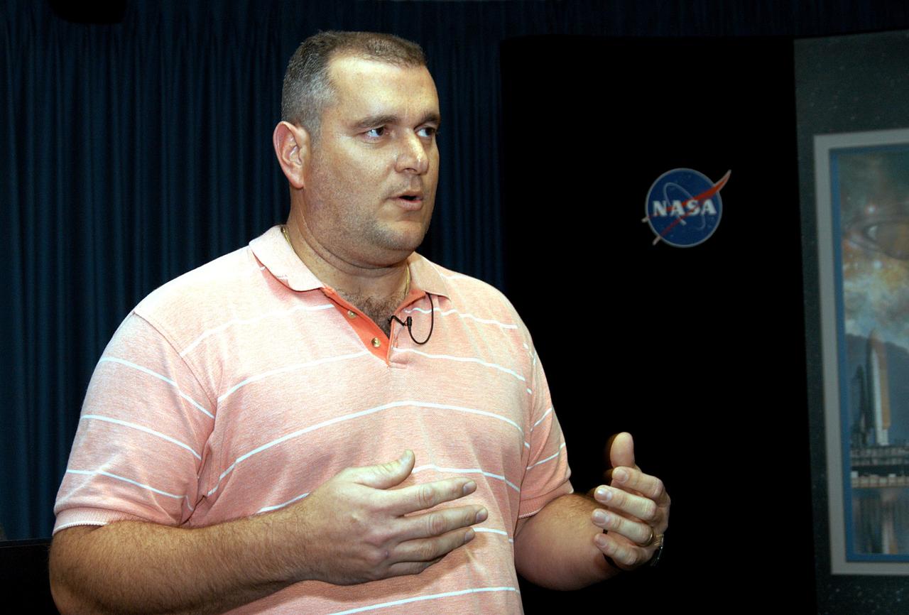 KENNEDY SPACE CENTER, FLA. - Armando Oliu, Final Inspection Team lead for the Shuttle program, speaks to reporters about the aid the Image Analysis Lab is giving the FBI in a kidnapping case. Oliu oversees the image lab that is using an advanced SGI® TP9500 data management system to review the tape of the kidnapping in progress in Sarasota, Fla. KSC installed the new $3.2 million system in preparation for Return to Flight of the Space Shuttle fleet. The lab is studying the Sarasota kidnapping video to provide any new information possible to law enforcement officers. KSC is joining NASA’s Marshall Space Flight Center in Alabama in reviewing the tape.