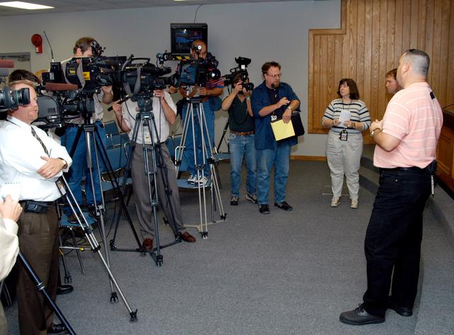 NASA image: KENNEDY SPACE CENTER, FLA. - Reporters are eager to hear from Armando Oliu about the aid the Image Analysis Lab is giving the FBI in a kidnapping case.  Oliu, Final Inspection Team lead for the Shuttle program, oversees the lab that is using an advanced SGI® TP9500 data management system to review the tape of the kidnapping in progress in Sarasota, Fla.  KSC installed the new $3.2 million system in preparation for Return to Flight of the Space Shuttle fleet.  The lab is studying the Sarasota kidnapping video to provide any new information possible to law enforcement officers.  KSC is joining NASA’s Marshall Space Flight Center in Alabama in reviewing the tape.