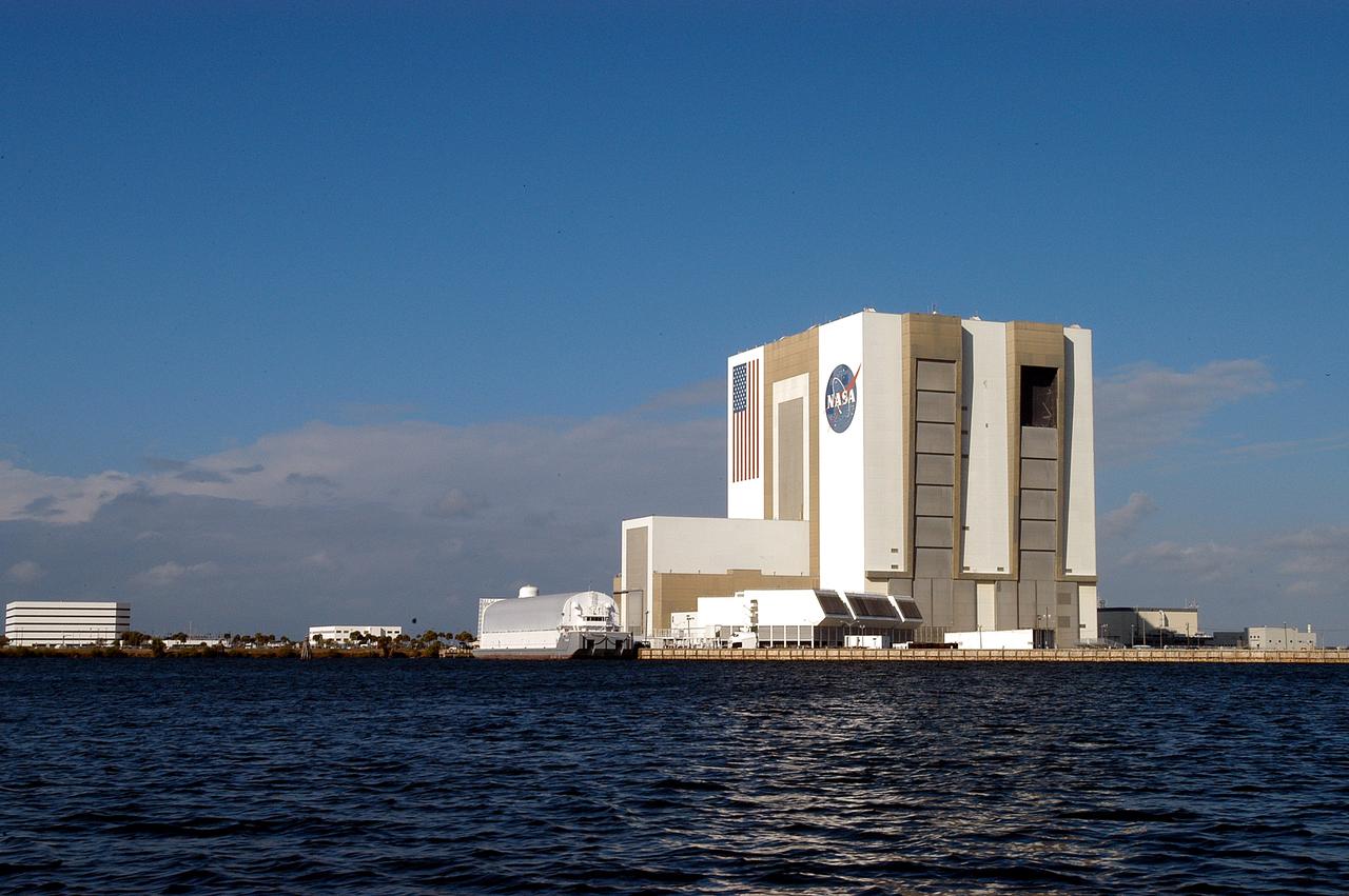 KENNEDY SPACE CENTER, FLA. - From a boat on the Banana River the Vehicle Assembly Building looms over the water.  The boat holds Karen Holloway-Adkins, KSC wildlife specialist, who is studying the life history of sea turtles, especially what they eat, where they lay their eggs and what factors might harm their survival.  On the boat trip she is also monitoring the growth of sea grasses and algae and the water quality of estuaries and lagoons used by sea turtles and other aquatic wildlife.