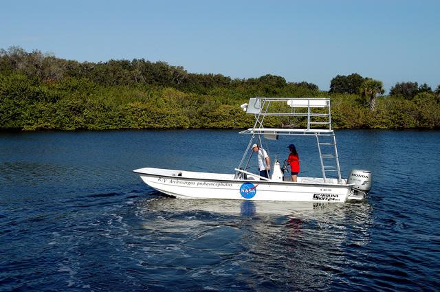NASA image: KENNEDY SPACE CENTER, FLA. - Karen Holloway-Adkins, KSC wildlife specialist, at the helm of a boat on the Banana River, heads for a research area.  She is studying the life history of sea turtles, especially what they eat, where they lay their eggs and what factors might harm their survival.  On the boat trip she is also monitoring the growth of sea grasses and algae and the water quality of estuaries and lagoons used by sea turtles and other aquatic wildlife.