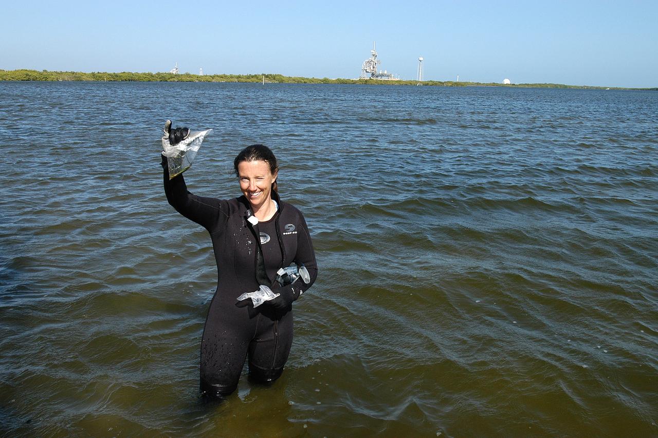 KENNEDY SPACE CENTER, FLA. - Karen Holloway-Adkins, KSC wildlife specialist, shows a sample of the sea grass she collected from the floor of the Banana River.  She is studying the life history of sea turtles, especially what they eat, where they lay their eggs and what factors might harm their survival.  On the boat trip she is also monitoring the growth of sea grasses and algae and the water quality of estuaries and lagoons used by sea turtles and other aquatic wildlife.