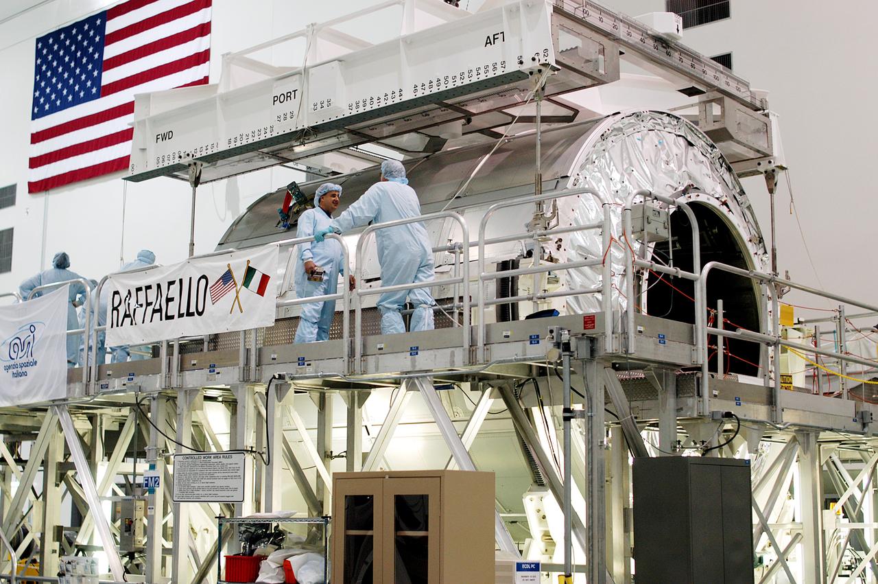 KENNEDY SPACE CENTER, FLA. - An overhead crane is attached to the Multi-Purpose Logistics Module Raffaello in order to move it to another work stand in the Space Station Processing Facility.  Raffaello is the second MPLM built by the Italian Space Agency, serving as a reusable logistics carrier and primary delivery system to resupply and return station cargo requiring a pressurized environment.  It is being moved to allow the third MPLM, Donatello, to be brought in for routine testing.  Donatello has been stored in the Operations and Checkout Building.  This is the first time all three MPLMs are in the SSPF; the other one is the Leonardo.  Raffaello is scheduled to fly on Space Shuttle Atlantis on mission STS-114.