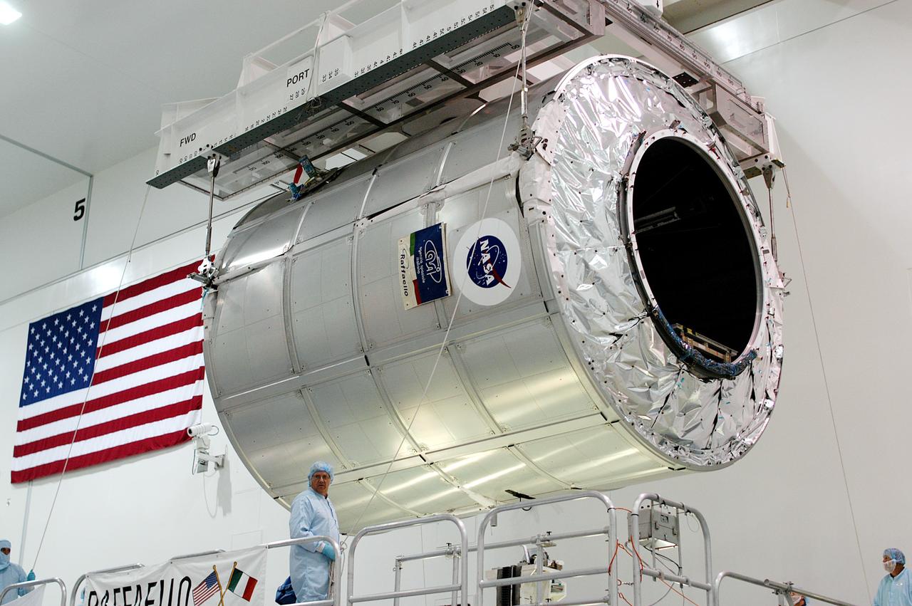 KENNEDY SPACE CENTER, FLA. - The Multi-Purpose Logistics Module Raffaello is lifted from its stand in the Space Station Processing Facility to move to another work stand.  Raffaello is the second MPLM built by the Italian Space Agency, serving as a reusable logistics carrier and primary delivery system to resupply and return station cargo requiring a pressurized environment.  It is being moved to allow the third MPLM, Donatello, to be brought in for routine testing.  Donatello has been stored in the Operations and Checkout Building.  This is the first time all three MPLMs are in the SSPF; the other one is the Leonardo.  Raffaello is scheduled to fly on Space Shuttle Atlantis on mission STS-114.