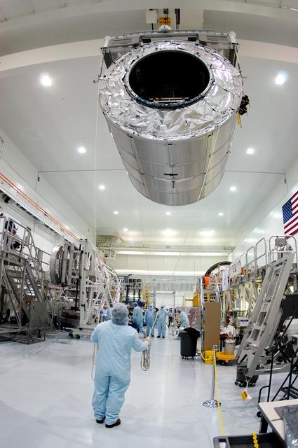 NASA image: KENNEDY SPACE CENTER, FLA. - In the Space Station Processing Facility, the Multi-Purpose Logistics Module Raffaello glides above the floor as it moves to another stand on the other side.  Raffaello is the second MPLM built by the Italian Space Agency, serving as a reusable logistics carrier and primary delivery system to resupply and return station cargo requiring a pressurized environment.  It is being moved to allow the third MPLM, Donatello, to be brought in for routine testing.  Donatello has been stored in the Operations and Checkout Building.  This is the first time all three MPLMs are in the SSPF; the other one is the Leonardo.  Raffaello is scheduled to fly on Space Shuttle Atlantis on mission STS-114.