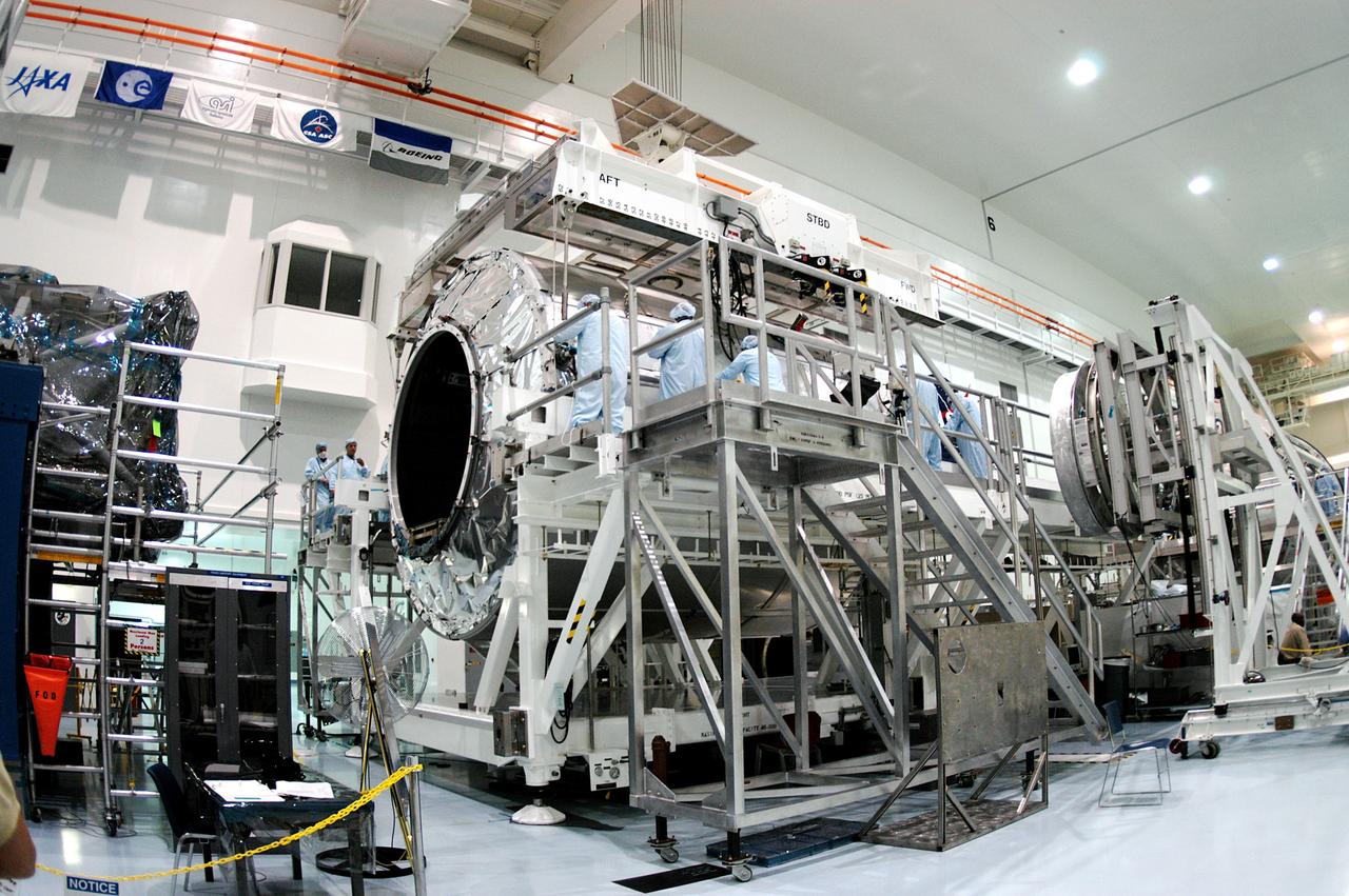 KENNEDY SPACE CENTER, FLA. - Workers in the Space Station Processing Facility prepare to release the overhead crane from the Multi-Purpose Logistics Module Raffaello now secure on a new work stand.  Raffaello is the second MPLM built by the Italian Space Agency, serving as a reusable logistics carrier and primary delivery system to resupply and return station cargo requiring a pressurized environment.  It has been moved to allow the third MPLM, Donatello, to be brought in for routine testing.  Donatello has been stored in the Operations and Checkout Building.  This is the first time all three MPLMs are in the SSPF; the other one is the Leonardo.  Raffaello is scheduled to fly on Space Shuttle Atlantis on mission STS-114.