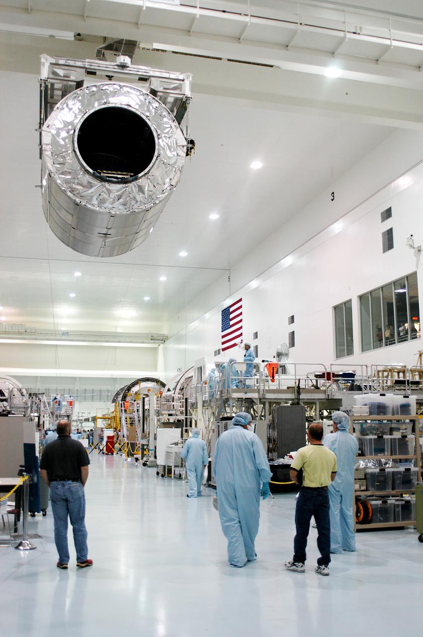 KENNEDY SPACE CENTER, FLA. - Workers on the floor of the Space Station Processing Facility watch as overhead cables carry the Multi-Purpose Logistics Module Donatello to a work stand.  Previously housed in the Operations and Checkout Building, Donatello was brought into the SSPF for routine testing.  This is the first time all three MPLMs (Donatello, Raffaello and Leonardo) are in the SSPF.  The MPLMs were built by the Italian Space Agency, to serve as reusable logistics carriers and the primary delivery system to resupply and return station cargo requiring a pressurized environment.  The third MPLM, Raffaello is scheduled to fly on Space Shuttle Atlantis on mission STS-114.