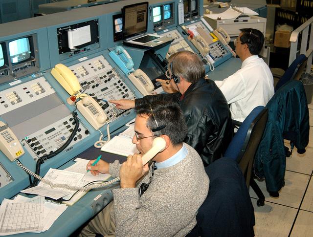 KENNEDY SPACE CENTER, FLA. - In the Launch Control Center, officials monitor the “Mode VII” emergency landing simulation being conducted at Kennedy Space Center and managed and directed from the LCC.  From left are Dr. Luis Moreno and Dr. David Reed, with Bionetics Life Sciences, and Dr. Philip Scarpa, with the KSC Safety, Occupational Health and Environment Division.  The purpose of the Mode VII is to exercise emergency preparedness personnel, equipment and facilities in rescuing astronauts from a downed orbiter and providing immediate medical attention.  This simulation presents an orbiter that has crashed short of the Shuttle Landing Facility in a wooded area 2-1/2 miles south of Runway 33.  Emergency crews are responding to the volunteer “astronauts” who are simulating various injuries inside the crew compartment mock-up.  Rescuers must remove the crew, provide triage and transport to hospitals those who need further treatment.  Local hospitals are participating in the exercise.