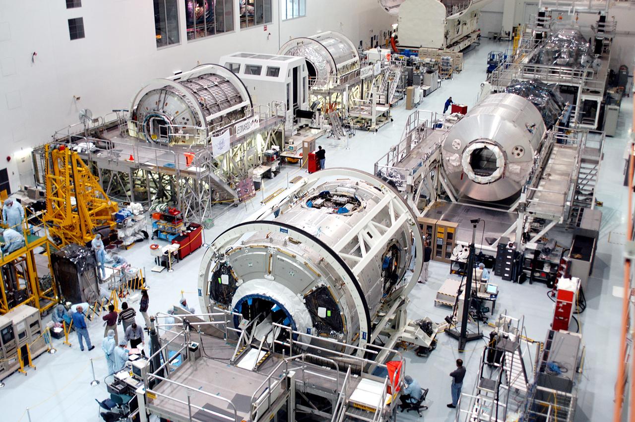 KENNEDY SPACE CENTER, FLA. - All three Multi-Purpose Logistics Modules are on the floor of the Space Station Processing Facility.  This is the first time the three - Leonardo, Raffaello and Donatello -- have been in one location.  Donatello has been stored in the Operations and Checkout Building since its arrival at KSC and was brought into the SSPF for routine testing. The MPLMs were built by the Italian Space Agency, to serve as reusable logistics carriers and the primary delivery system to resupply and return station cargo requiring a pressurized environment.  Raffaello is scheduled to fly on Space Shuttle Atlantis on mission STS-114.