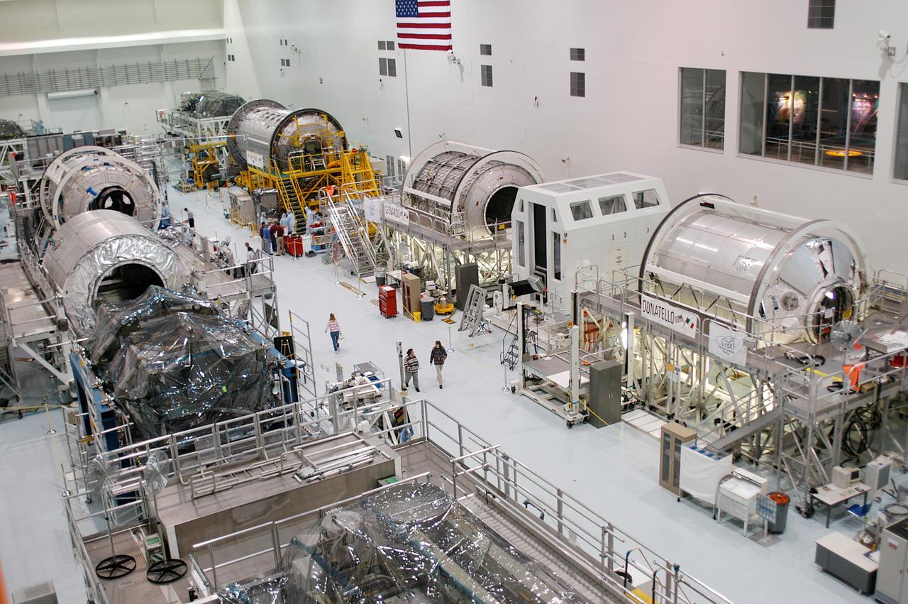 KENNEDY SPACE CENTER, FLA. - All three Multi-Purpose Logistics Modules are on the floor of the Space Station Processing Facility.  This is the first time the three - Leonardo, Raffaello and Donatello -- have been in one location.  Donatello has been stored in the Operations and Checkout Building since its arrival at KSC and was brought into the SSPF for routine testing. The MPLMs were built by the Italian Space Agency, to serve as reusable logistics carriers and the primary delivery system to resupply and return station cargo requiring a pressurized environment.  Raffaello is scheduled to fly on Space Shuttle Atlantis on mission STS-114.
