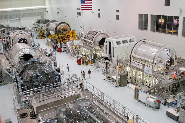 NASA image: KENNEDY SPACE CENTER, FLA. - All three Multi-Purpose Logistics Modules are on the floor of the Space Station Processing Facility.  This is the first time the three - Leonardo, Raffaello and Donatello -- have been in one location.  Donatello has been stored in the Operations and Checkout Building since its arrival at KSC and was brought into the SSPF for routine testing. The MPLMs were built by the Italian Space Agency, to serve as reusable logistics carriers and the primary delivery system to resupply and return station cargo requiring a pressurized environment.  Raffaello is scheduled to fly on Space Shuttle Atlantis on mission STS-114.